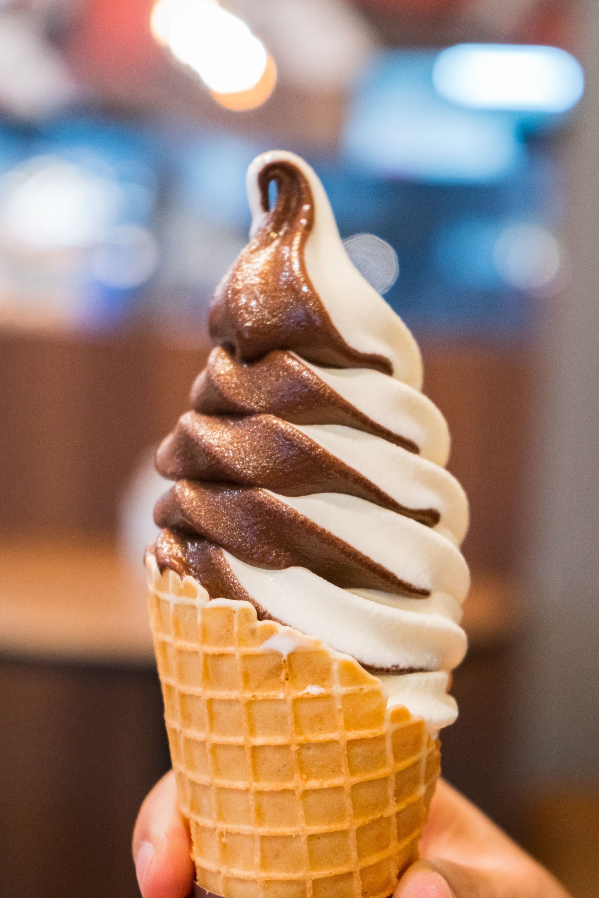 Soft serve ice cream of vanilla and chocolate on hand.